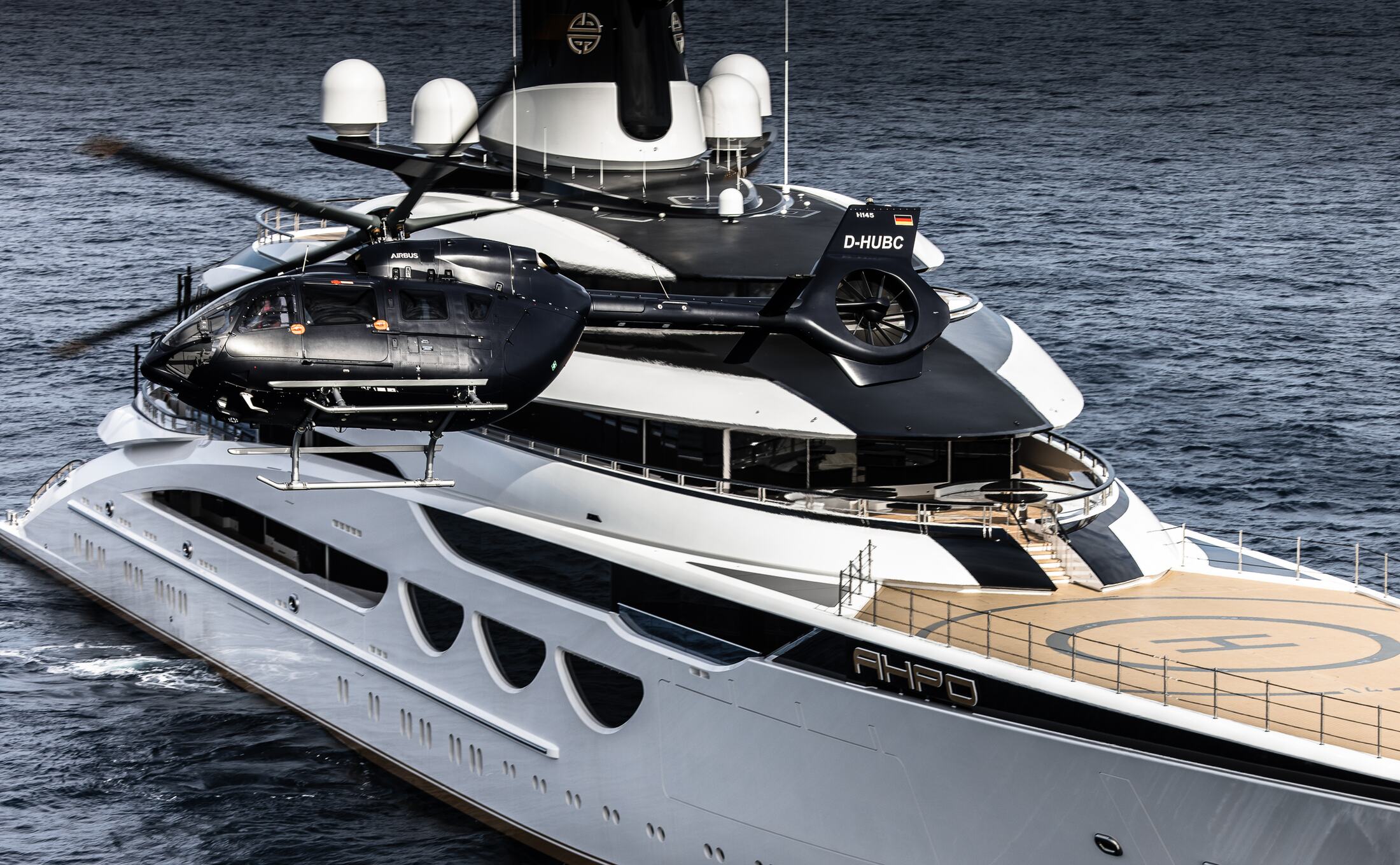 H145 in front of the superstructure of a superyacht