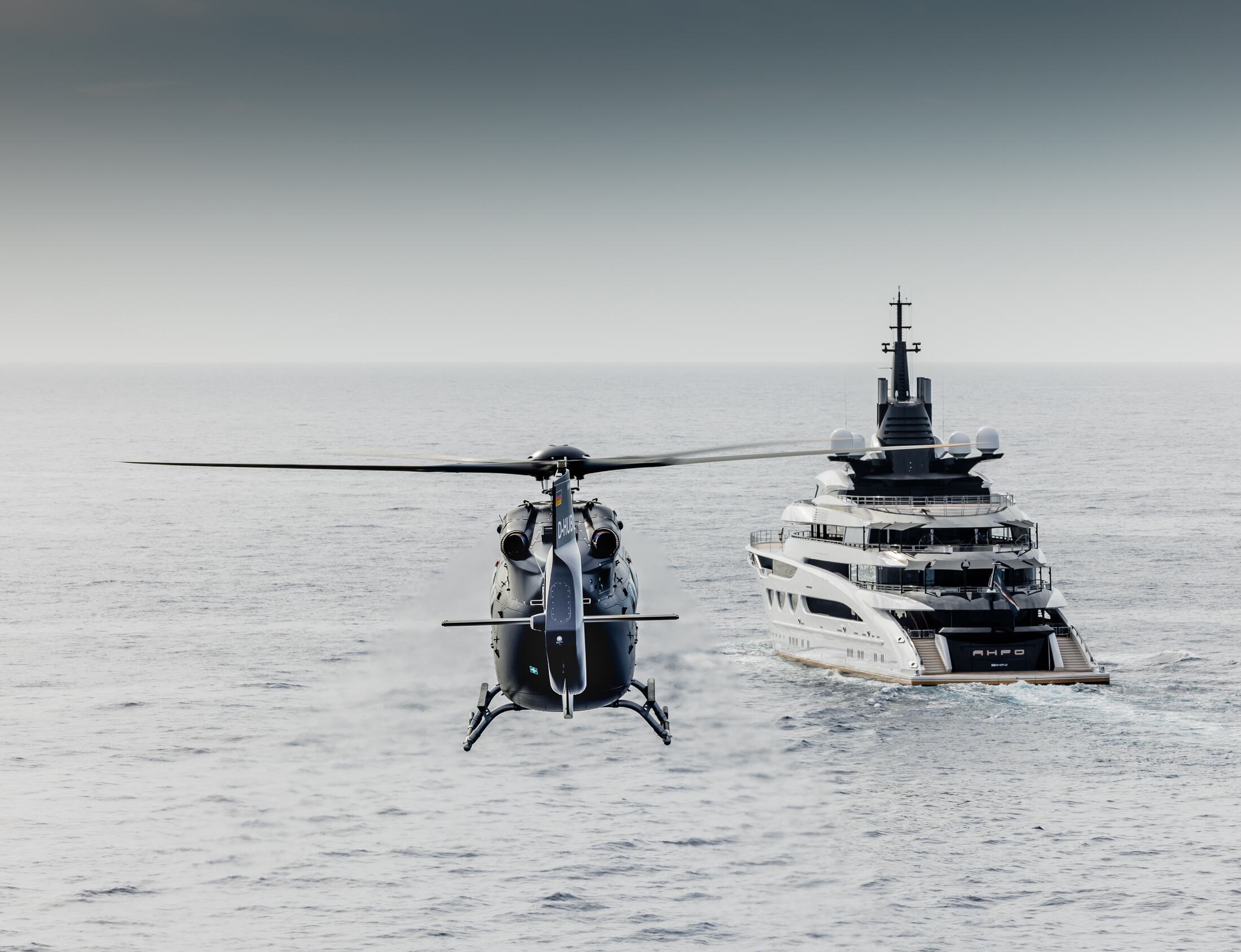 H145 on approach, superyacht in the background