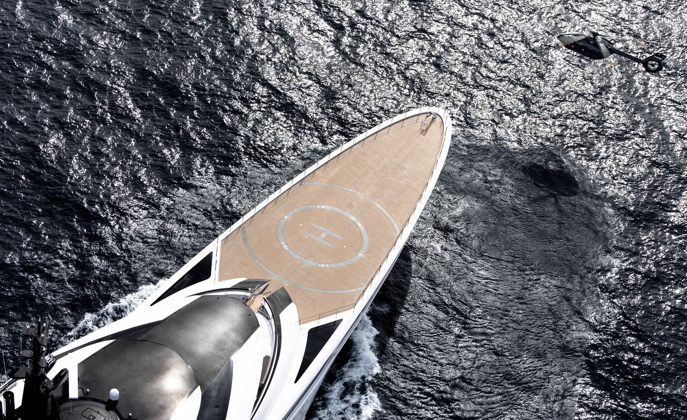 H145 approaching the helideck of a superyacht, aerial view